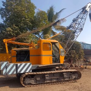 A large crane being inspected and maintained by workers at a construction site, promoting safety and long-term performance.