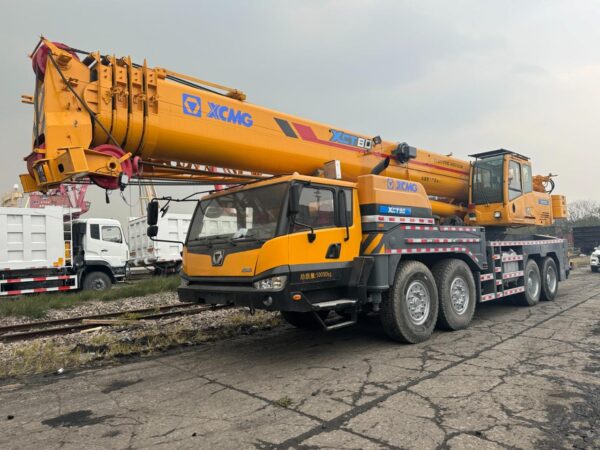 A powerful used crane lifting heavy materials at a construction site.